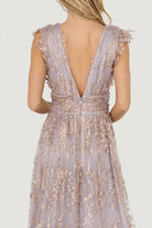 Motion shot of flowing maxi skirt with leg slit, showcasing movement, shimmer overlay, and subtle rose-gold sparkle.