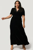 Close-up of black velvet fabric texture and subtle sheen on the Artemis tiered maxi dress, highlighting soft hand and pile.