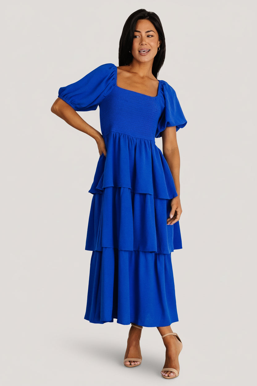 Detail view of short sleeve with elastic cuff and textured polyester fabric in cobalt, illustrating sleeve shape and fabric weight.