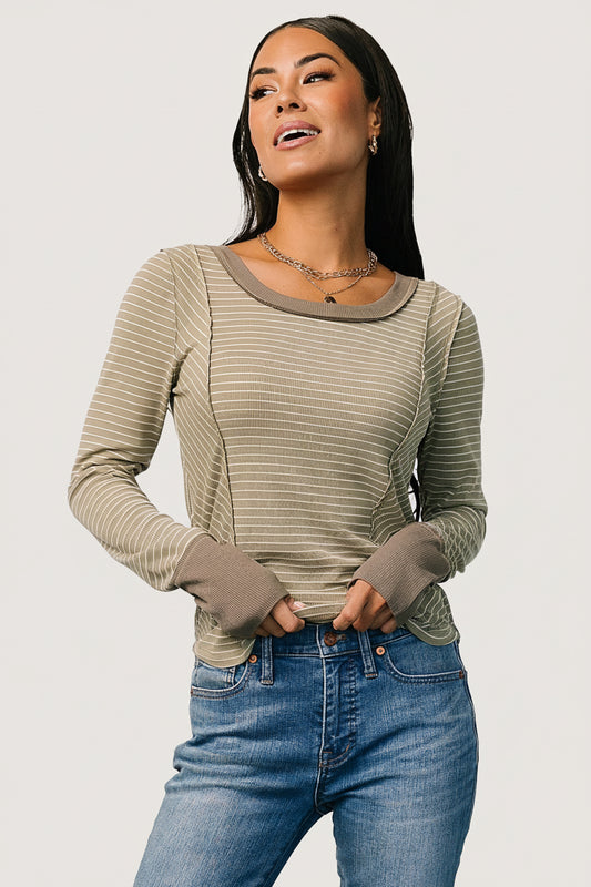 Front view of olive green striped long-sleeve top with white stripes, round neckline, contrast cuffs and visible seaming details.