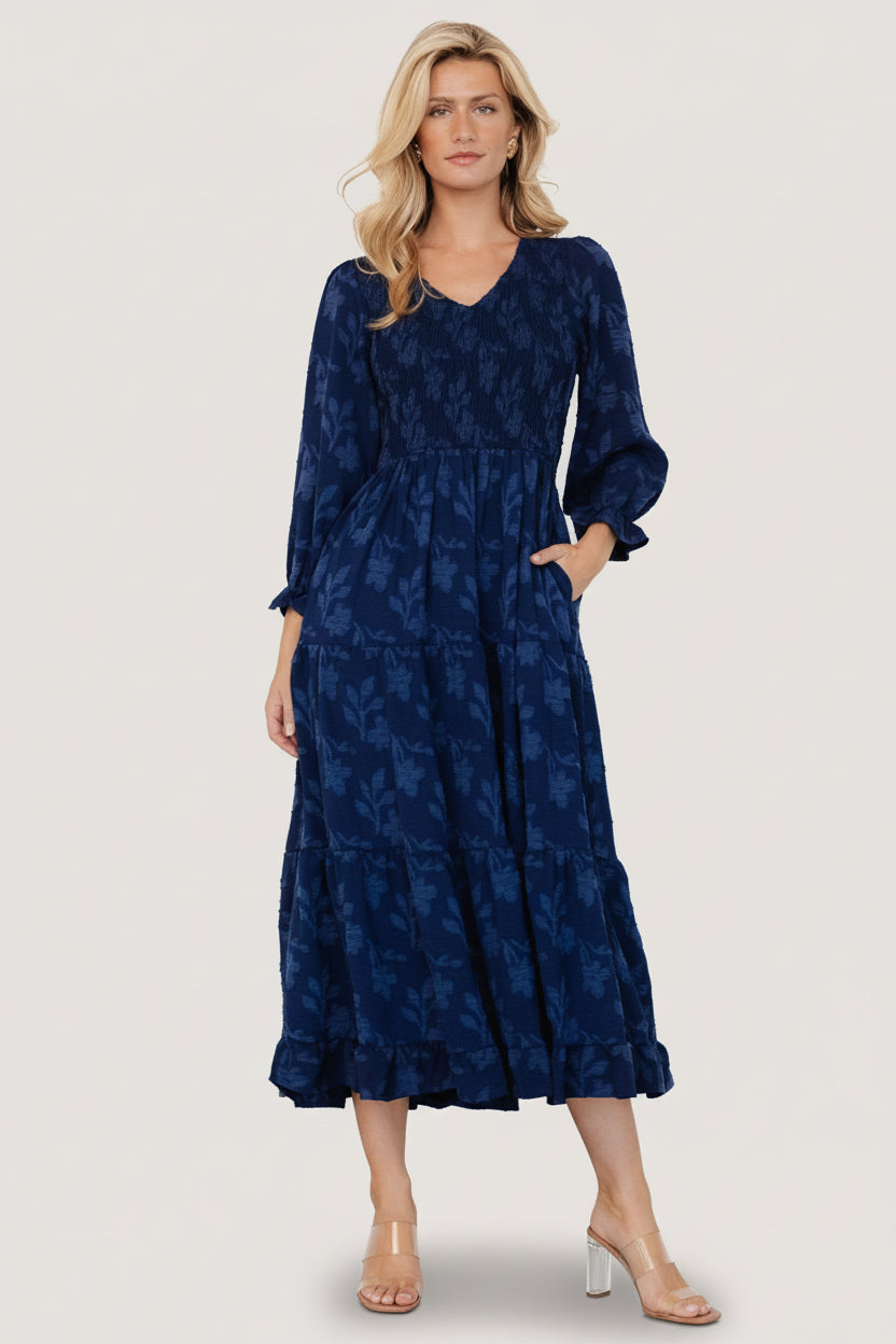 Fabric close-up of navy floral burnout texture and print scale to show fabric weight and pattern detail for online shoppers.