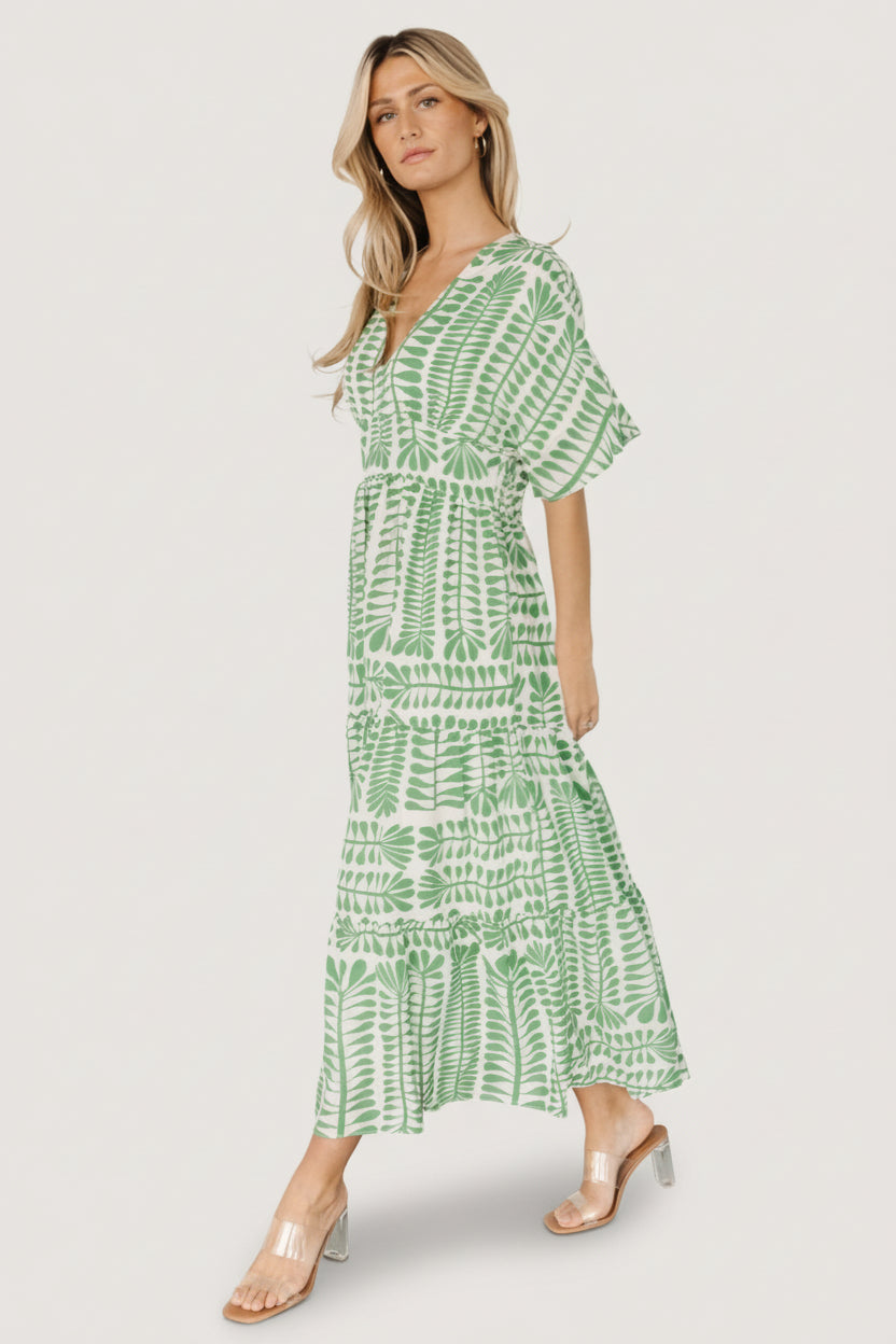 Detail image showing sleeve and hem movement of the Austin Kimono Dress in green print, ideal for vacation and everyday wear.