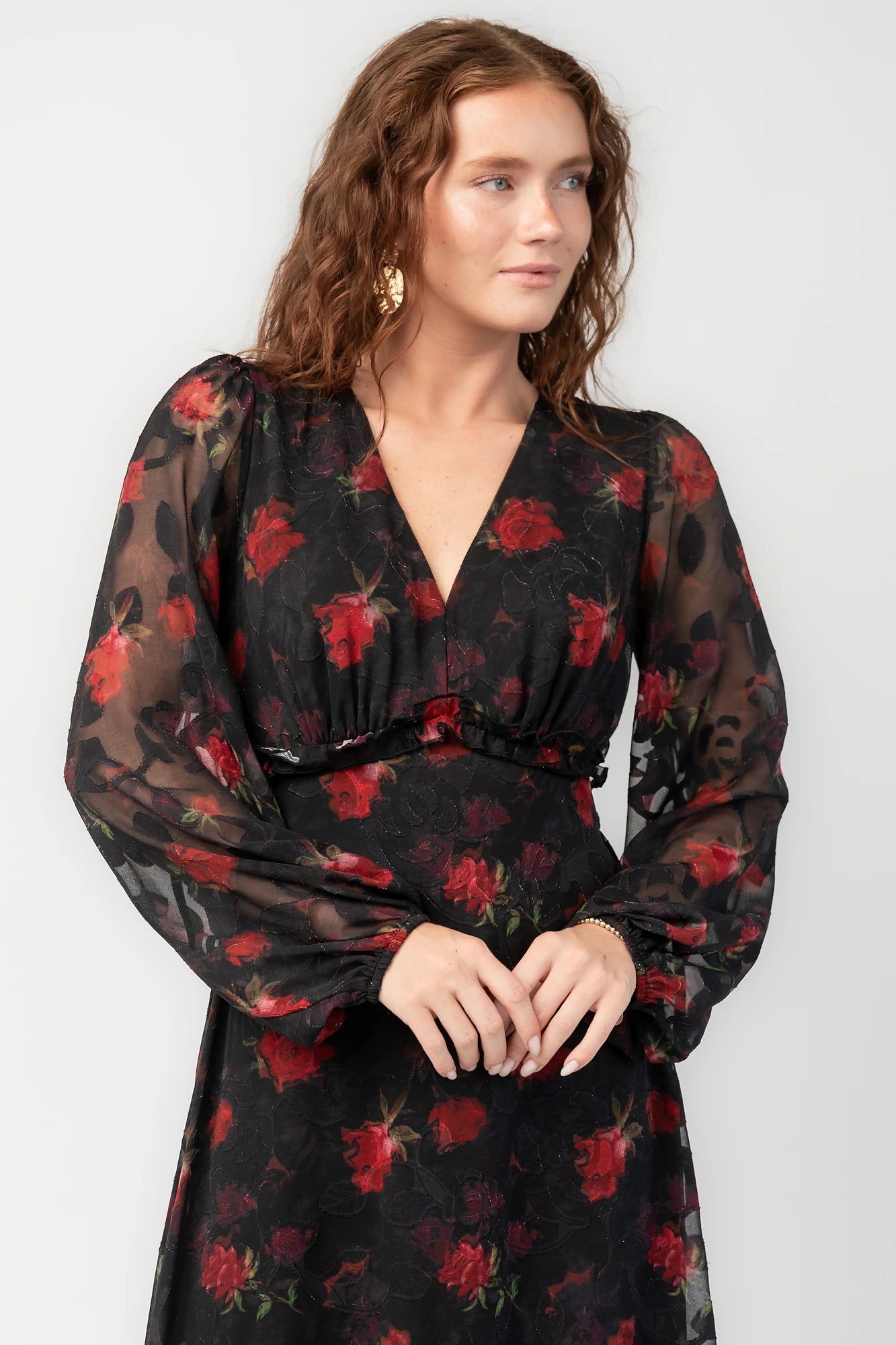 Avalora Midi Dress in Black Rose Floral with V-neckline, sheer long sleeves, smocked waist, and ruffle tier.