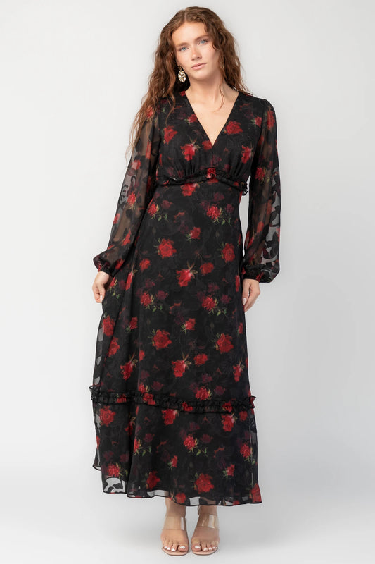 Avalora Midi Dress in Black Rose Floral with V-neckline, sheer long sleeves, smocked waist, and ruffle tier.