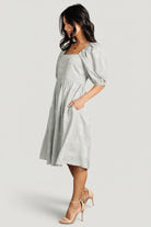 Sleeve detail showing mid-length puff shape, elastic at the shoulder and cuff, and unlined sleeve construction.