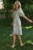 Close-up showing functional side pocket and smooth lined bodice and skirt fabric on the sage short dress.