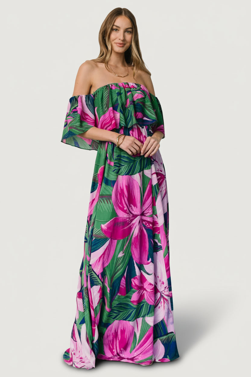 Front view of Azalea off-shoulder maxi dress in dark green with bright fuchsia floral print on model, showing bodice overlay and full skirt (front).