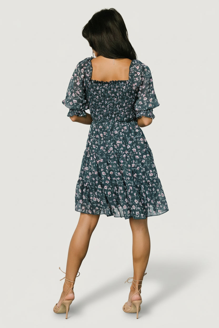 Side view of Azlyn smocked short dress showing semi-sheer 3/4 sleeves with smocked ruffle cuffs and on/off shoulder styling option.