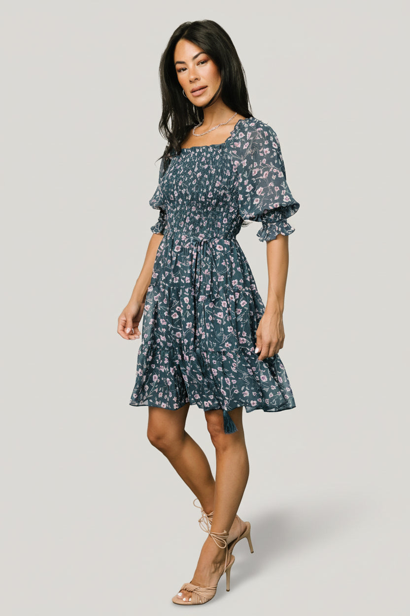 Close-up of smocked bodice and square ruffled neckline on the Azlyn dress, highlighting jacquard chiffon texture and ruffled elastic detail.