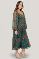 Detail of the sweetheart neckline and descending point bodice on the Babette Basque Waist midi dress in teal multi floral.