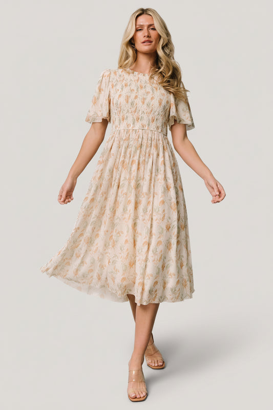 Front view of Bailey Smocked Midi Dress in ivory with gold and green floral print, showing smocked bodice and ruffled neckline.