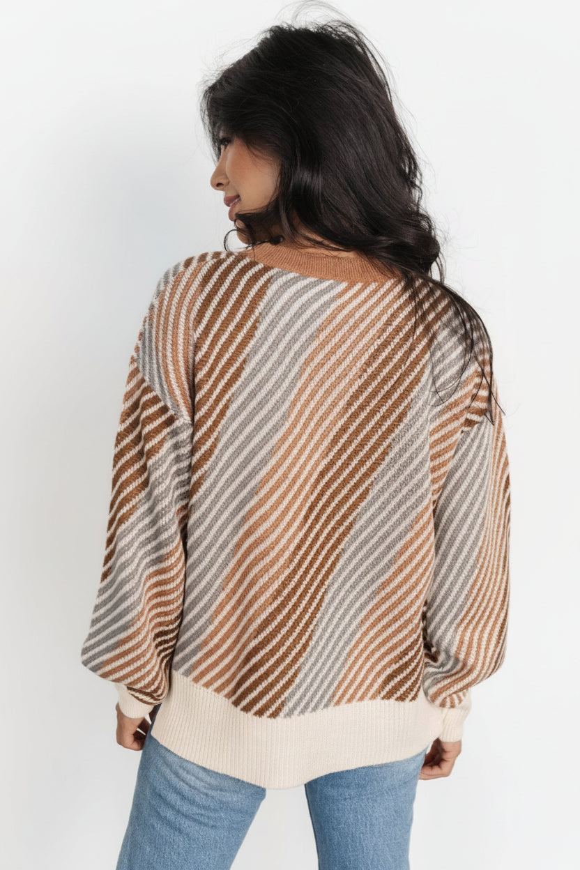 Side view of Baldwin multi-color striped sweater showing split hem, ribbed sleeve cuff, and bubble sleeve silhouette in a soft knit fabric.