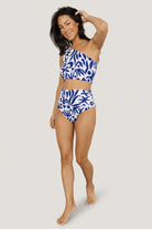 Front view of white and navy abstract high-rise bikini bottom with high-cut, cheeky silhouette and side ruching for a flattering fit.