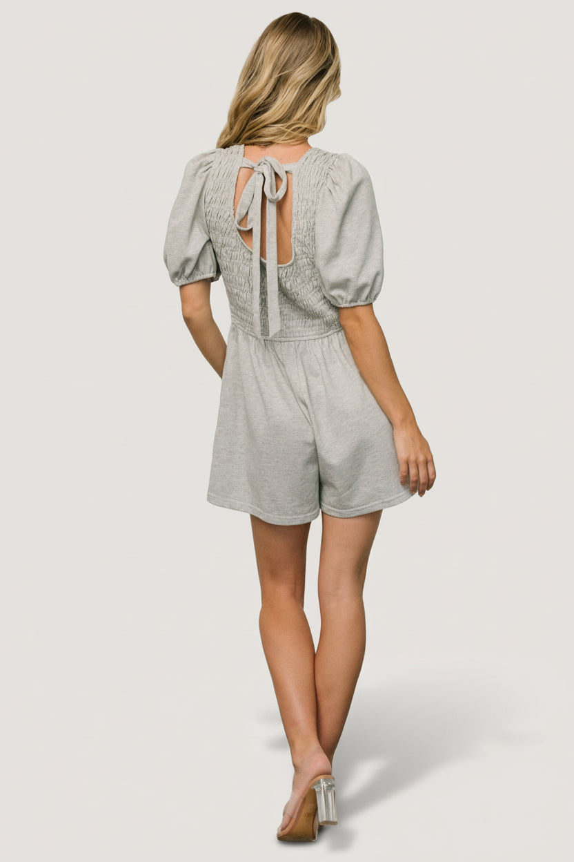 Close-up of Beaumont Romper fabric and smocking showing jersey texture and subtle blue flecks in heather gray.