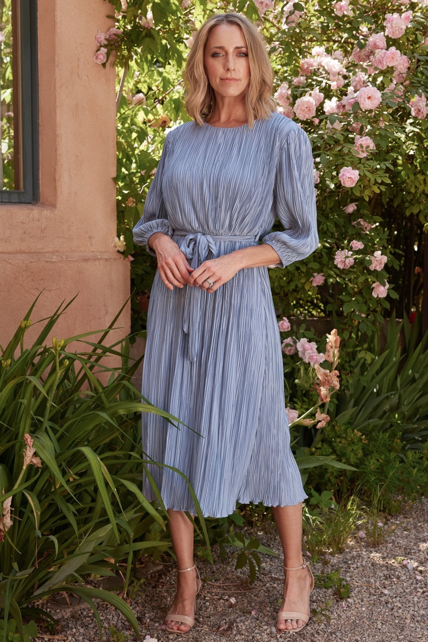 Close-up of elbow-length balloon sleeve and elastic cuff on the Bethany Pleated Midi Dress, showing fabric texture and sleeve volume.