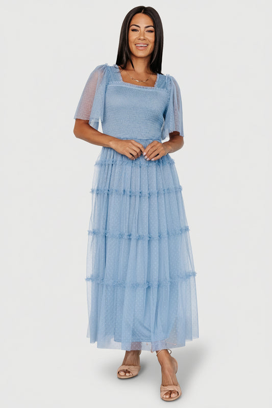 Front view of dusty blue dotted tulle midi dress showing elastic square neckline, smocked bodice and tiered ruffle skirt.
