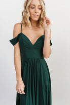 Detail shot of lace overlay and fabric drape on the emerald maxi dress, illustrating the lightweight 100% polyester construction.