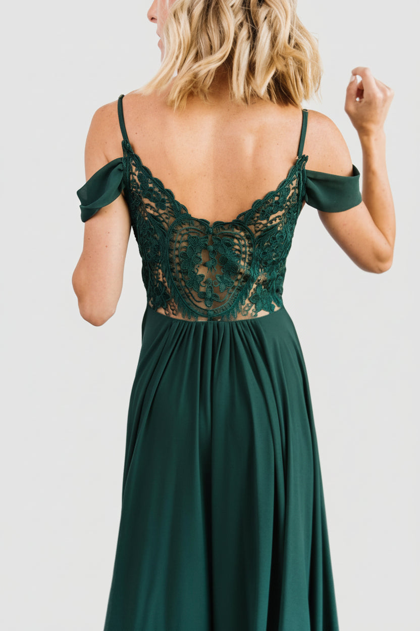 Model wearing Bianca Lace Maxi Dress in emerald, showcasing full length, ruching at waist and how the skirt flows with movement.