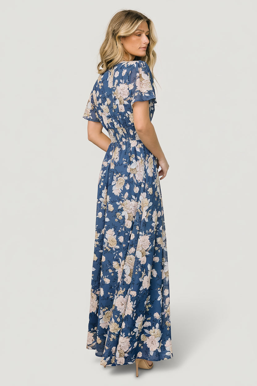 Styled look of Birdie maxi dress with accessories; ideal wedding guest outfit featuring flutter sleeves and flattering V-neckline.