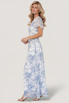 Model wearing the Birdie Maxi Dress in an outdoor setting, showing natural movement and floor-length hem.