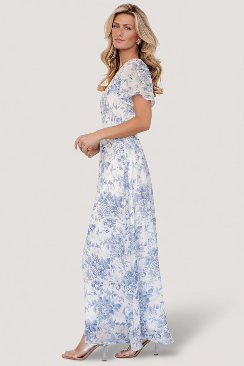 Model wearing the Birdie Maxi Dress in an outdoor setting, showing natural movement and floor-length hem.