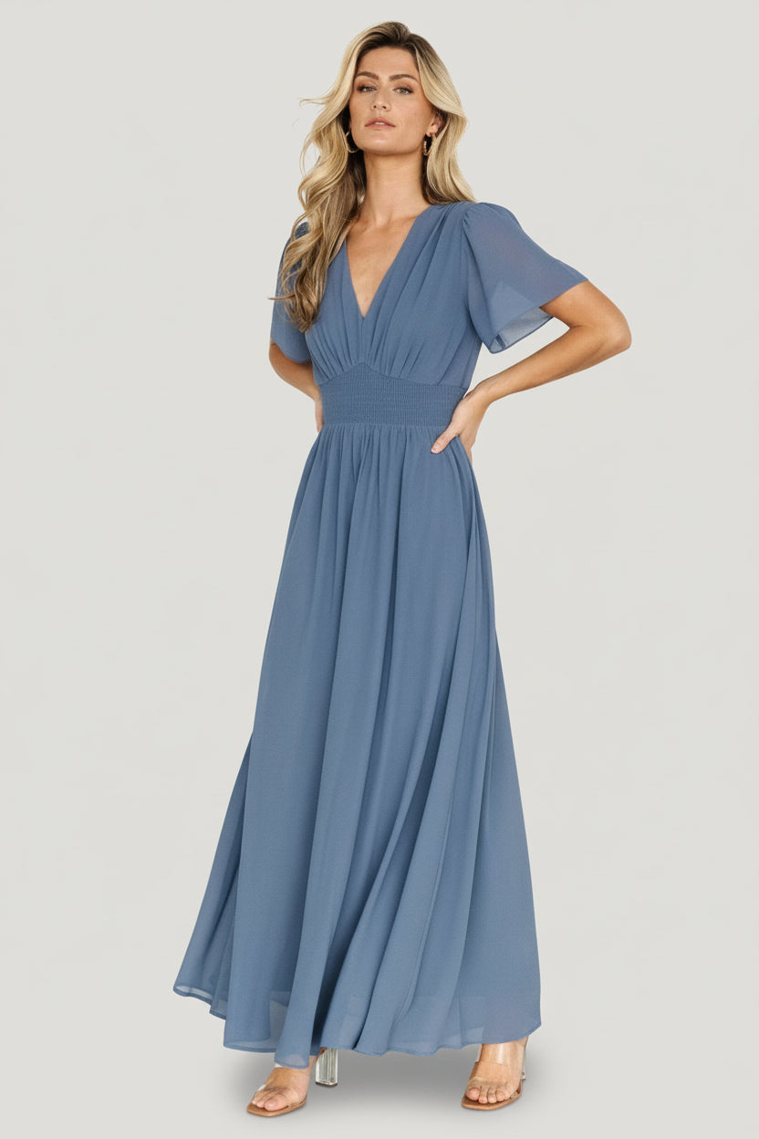 Front view of Birdie Maxi Dress in Whisper Blue on a model showing V-neckline, smocked waist, full-length chiffon drape and elegant silhouette.