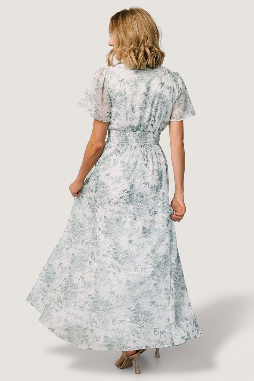 Close-up of the Birdie Maxi Dress smocked waist and V-neckline highlighting fabric texture and feminine gathers.