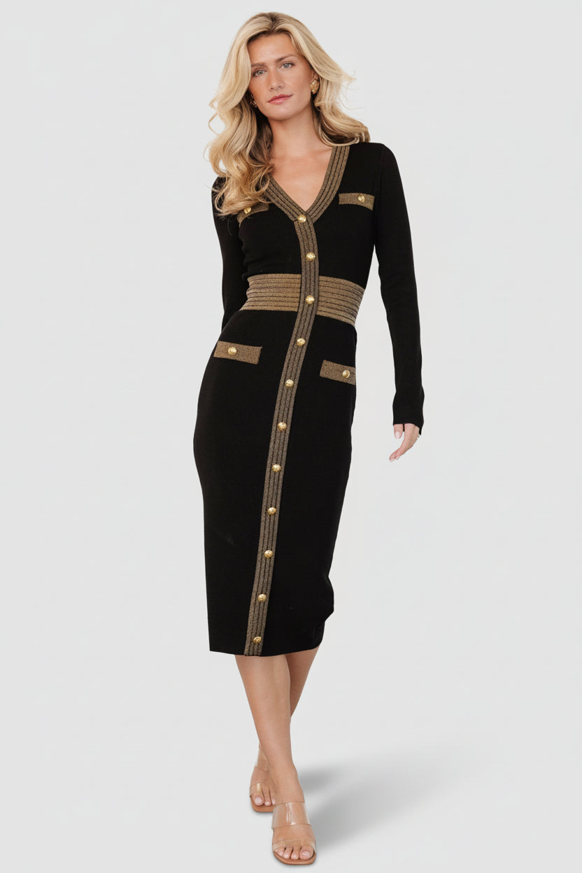 Full-length front view of the Birgitta ribbed midi dress in black with gold metallic accents, V-neck, and decorative buttons.