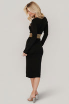 Detail of long fitted sleeve with raw hem and ribbed knit texture showing metallic thread woven through the fabric.