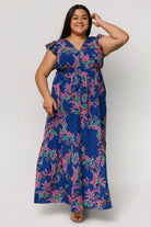 Close-up of bodice showing V-neckline, functional buttons, and subtle lurex thread woven through the indigo print.