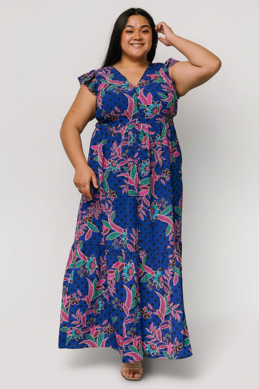 Close-up of bodice showing V-neckline, functional buttons, and subtle lurex thread woven through the indigo print.