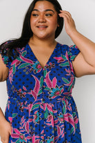 Model wearing the indigo dress styled with sandals; image shows functional side pocket access and natural fabric drape.
