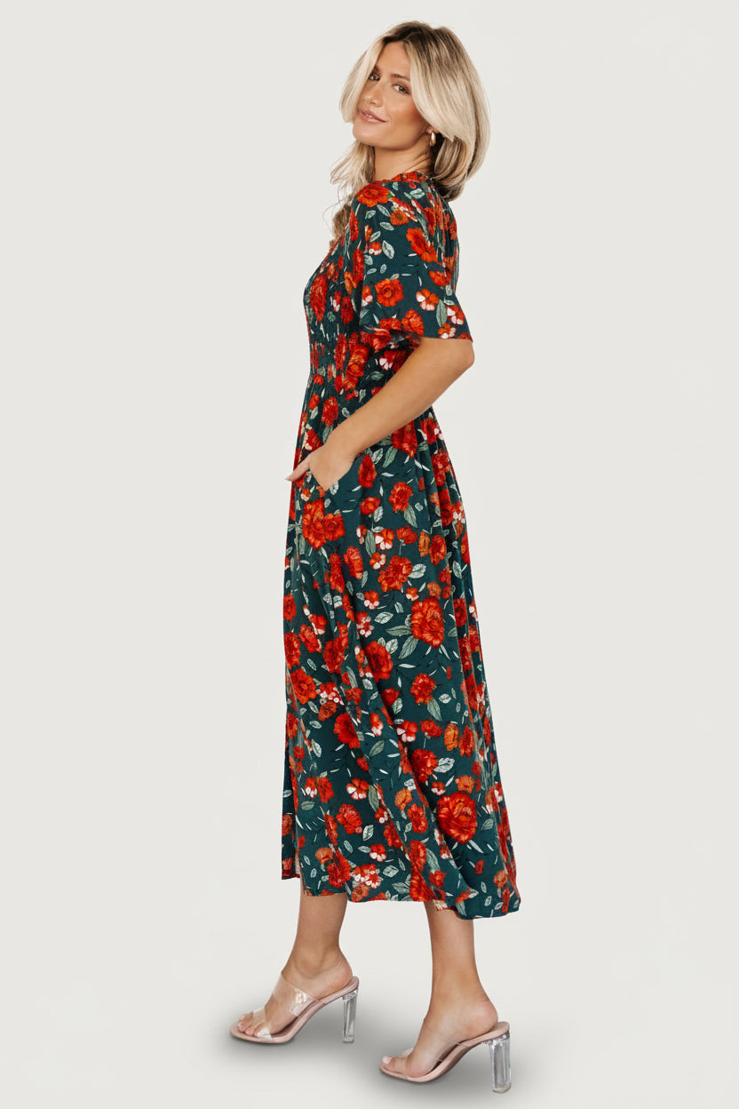 Back view of Polagram Botega Midi Dress in jade multi floral highlighting the attached lining and soft drape of the midi skirt.