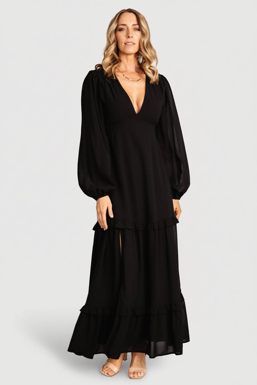 Front view of black Bowman Deep V maxi dress on model showing plunge V-neck, elastic back waist, and flowing ruffle-tiered skirt for event wear.