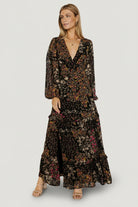 Detail shot of ruffle-tiered skirt and multi-colored floral print on lightweight chiffon-style polyester fabric.
