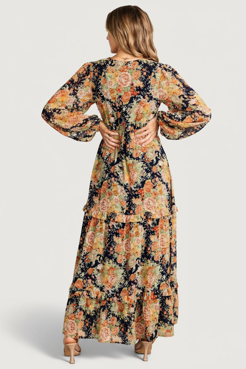 Full-length shot of navy floral chiffon ruffle-tiered maxi dress with long sleeves and plunging V-neckline for styling reference.