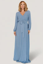 Detail image of long sleeve with elastic cuff on Breanne Faux Wrap Maxi Dress in slate blue showing fabric texture and cuff finish.