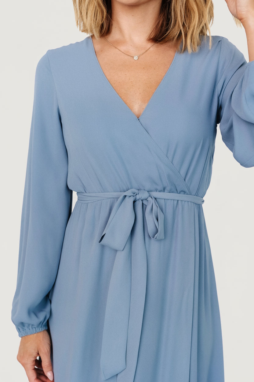 Back view of the Breanne Faux Wrap Maxi Dress in slate blue showing full skirt length and fitted waistline with smooth, fully lined finish.