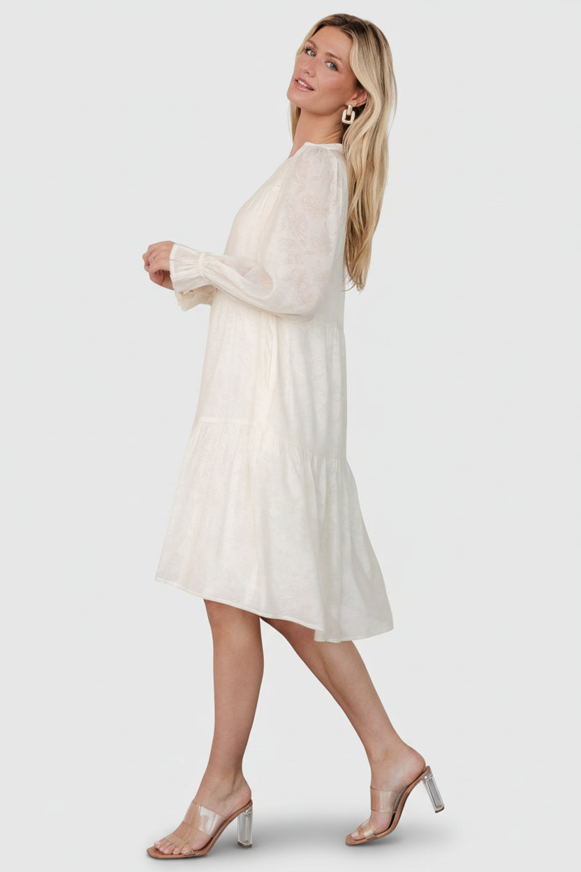 Back view of cream Brenna button midi dress displaying the relaxed silhouette and midi-length hemline.