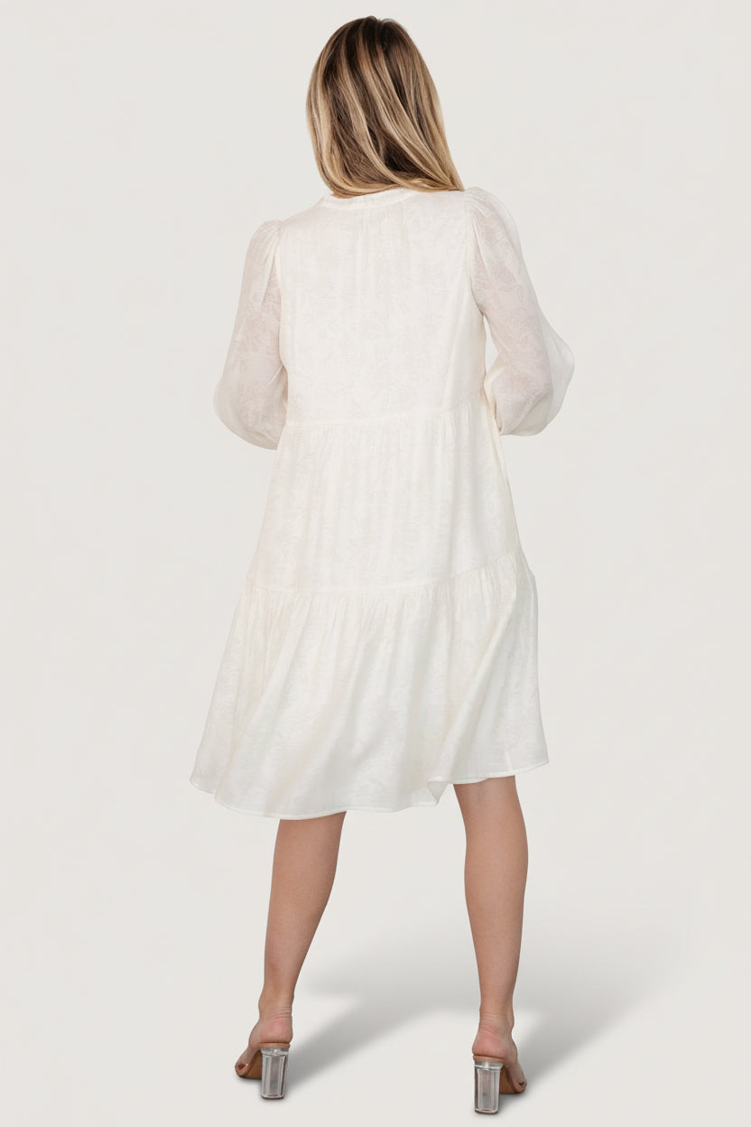 Detail shot of sleeve cuff and side pocket on the Brenna cream midi dress, highlighting the elastic cuff and pocket opening.