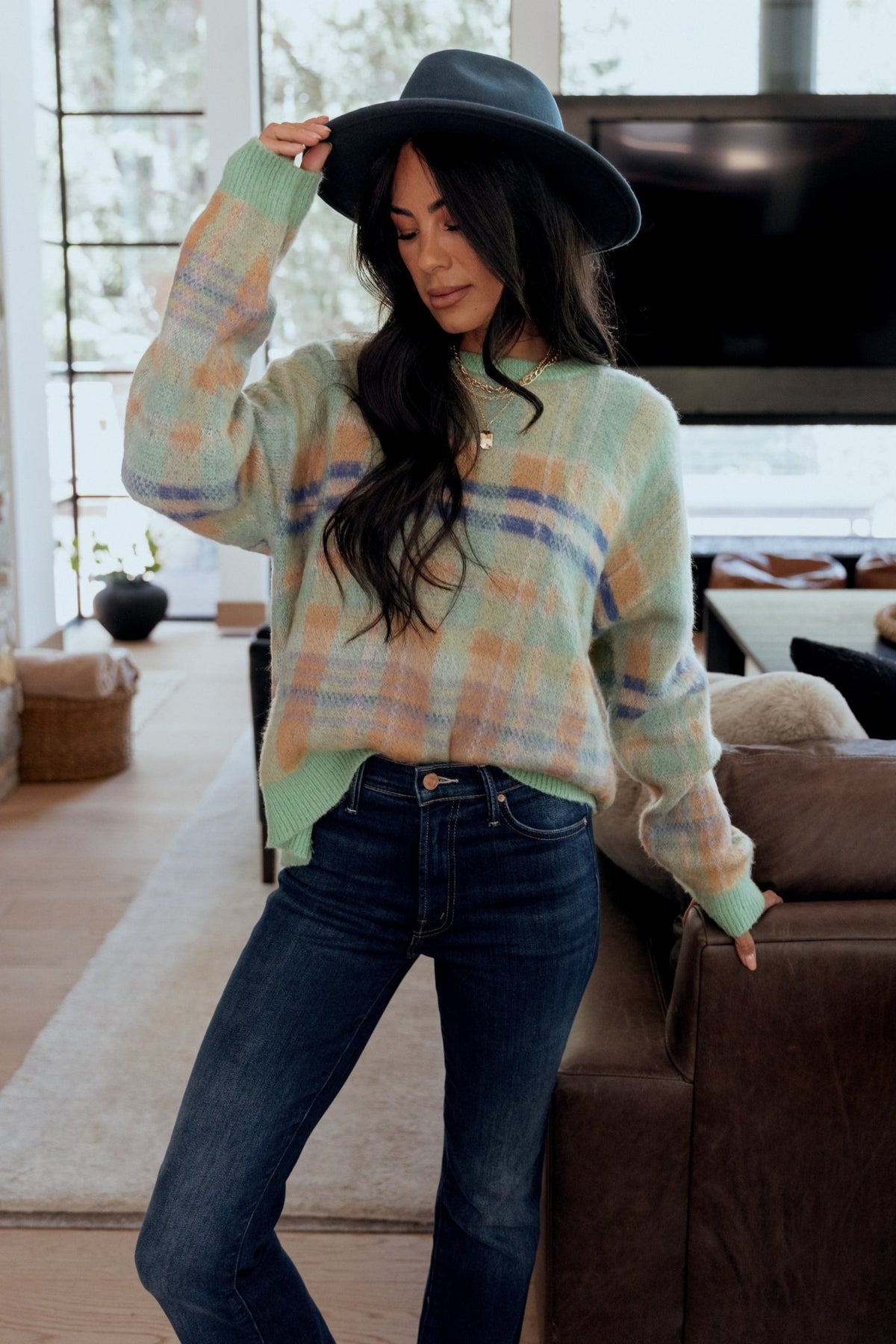 Close view of neckline and shoulder showing chunky round collar and soft knit construction for easy layering and comfort.
