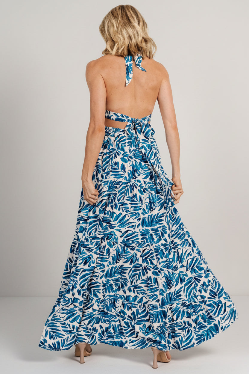 Close-up of halter tie and bodice showing lined bust construction, tie-neck detail, and the cobalt print texture on rayon fabric.