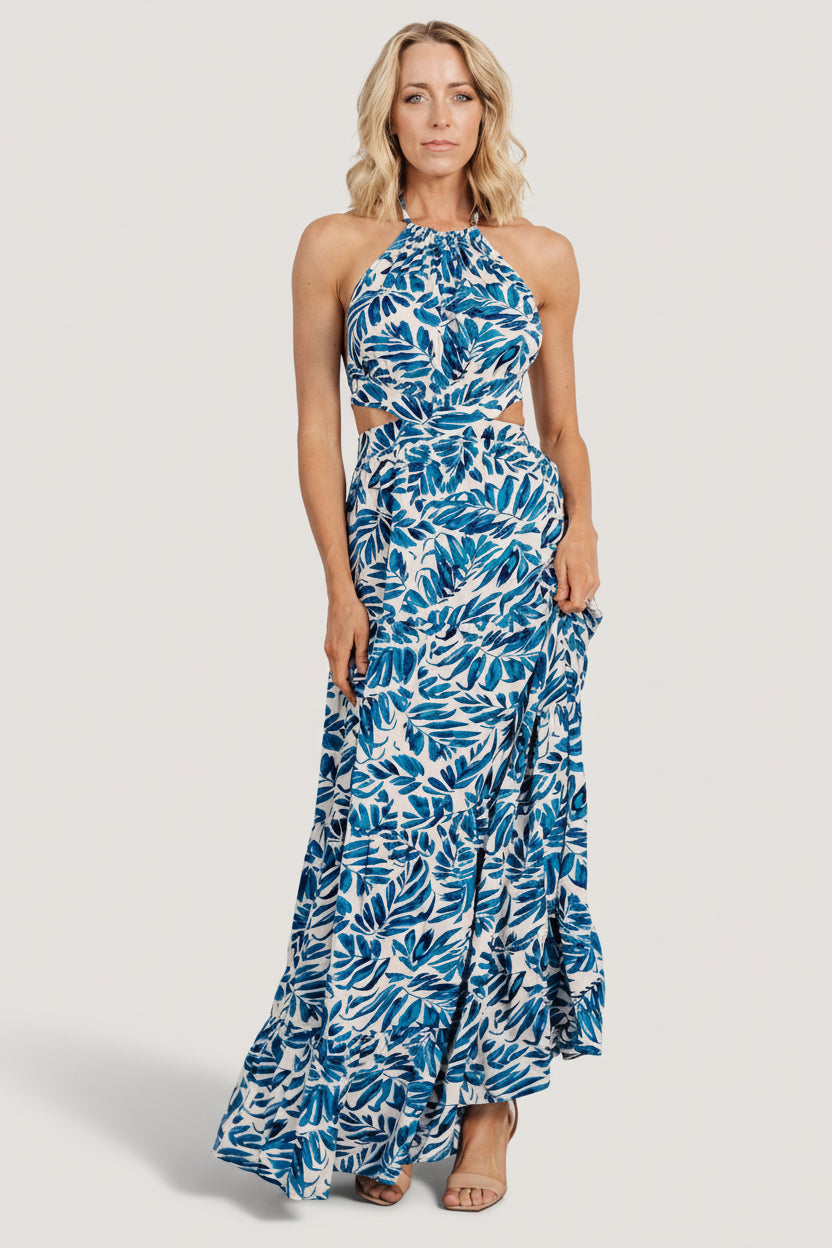 Front view of cobalt print halter maxi dress showing tie-neck, lined bust, elastic back waist and flowing unlined skirt.