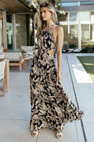 Side view of tiered maxi skirt in navy tropical print, highlighting unlined flow and graceful movement across the hem.