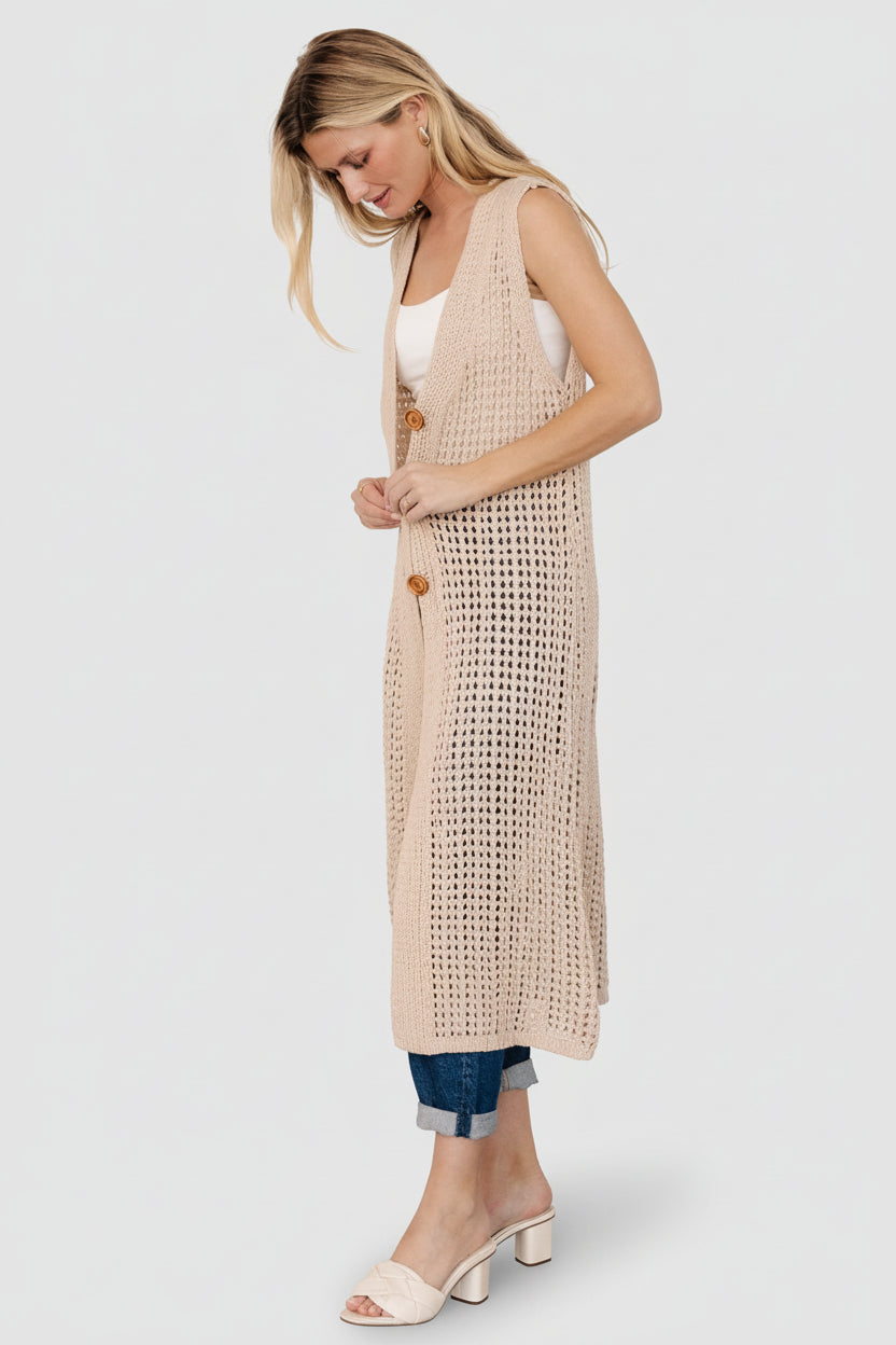 Close-up of the three brown functional buttons and V-neck detailing on the Bretta Duster Vest, highlighting button finish and knit stitch.