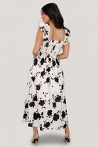 Back detail of the midi dress highlighting smocked back panel and elastic at the waist for a comfortable fit.