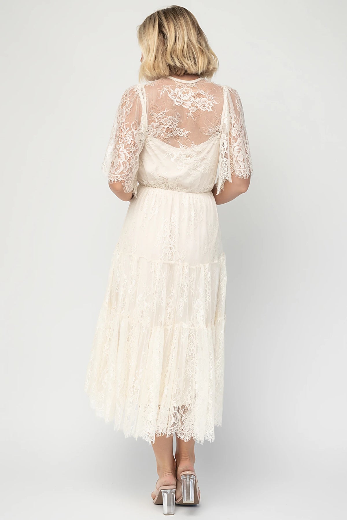 Brittany Lace Midi Dress in Vintage Cream with deep V-neck, sheer lace sleeves, elastic waist, and tiered skirt.