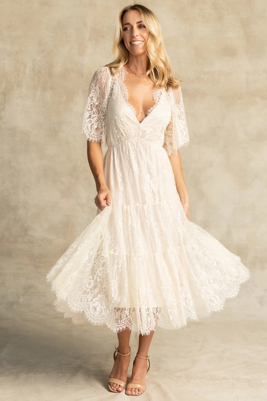 Brittany Lace Midi Dress in Vintage Cream with deep V-neck, sheer lace sleeves, elastic waist, and tiered skirt.