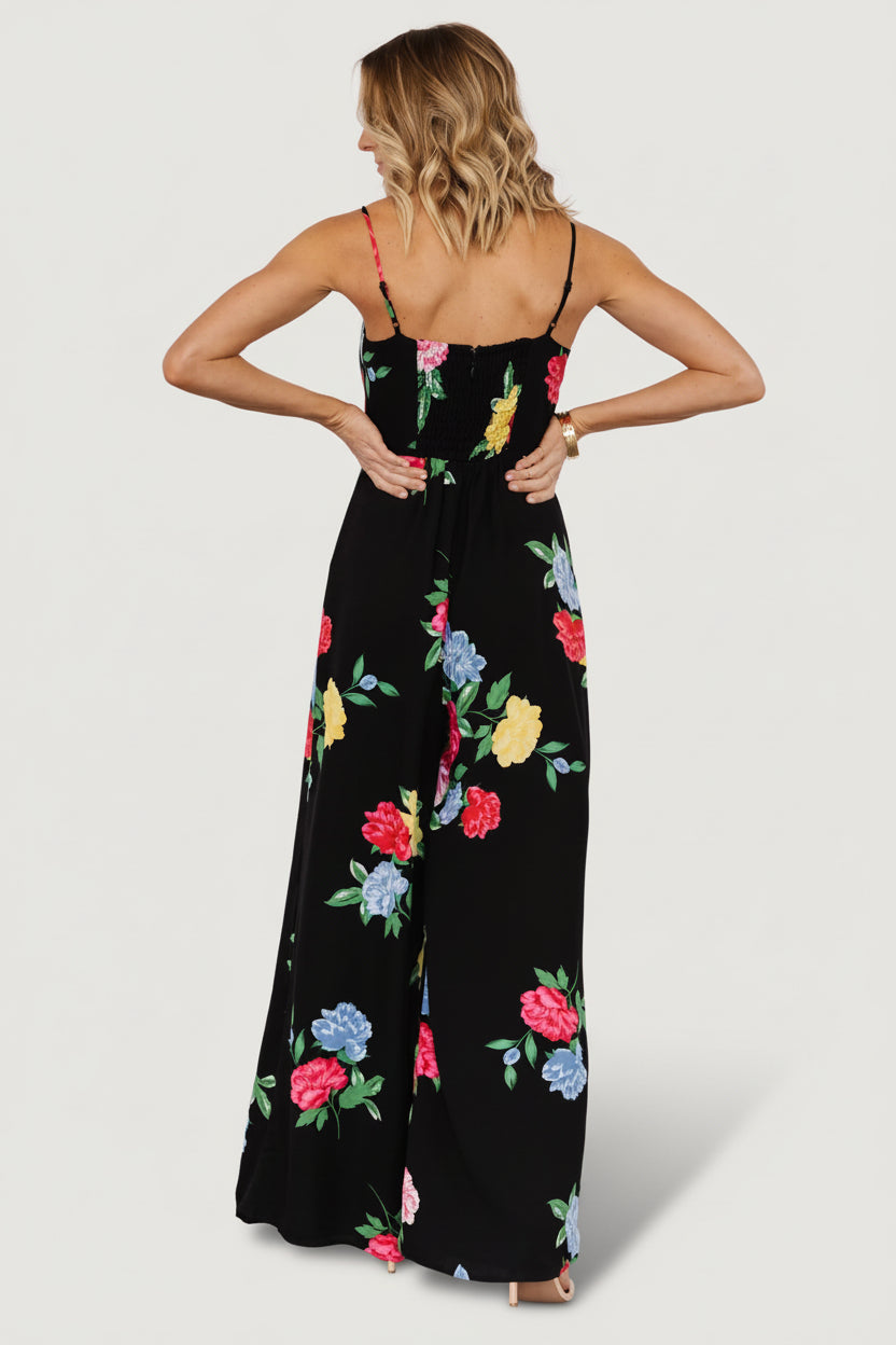 Detail of the flowing wide-leg silhouette and fully lined interior of a black floral jumpsuit designed for movement and evening wear.