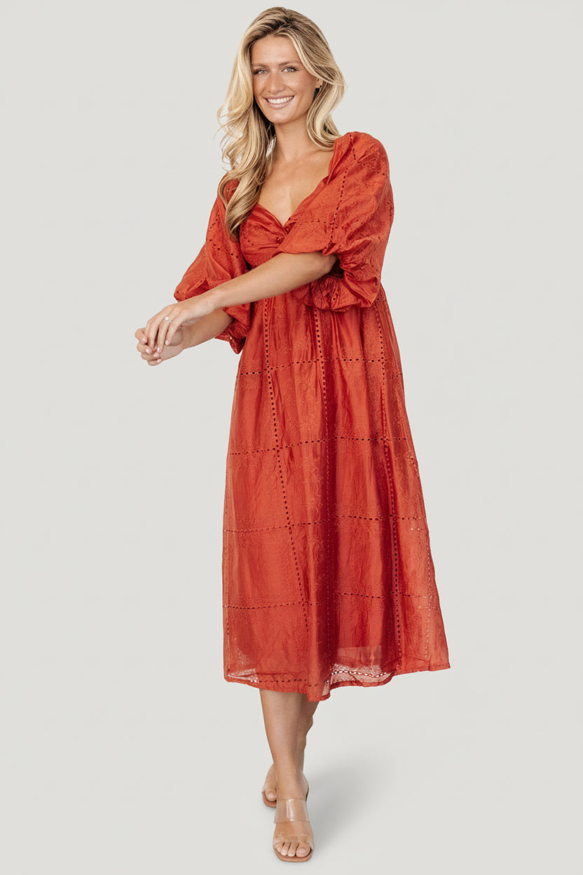 Detail shot of Brynn rust dress bust area with sweetheart neckline, twist detail, and keyhole under-bust for subtle shaping.